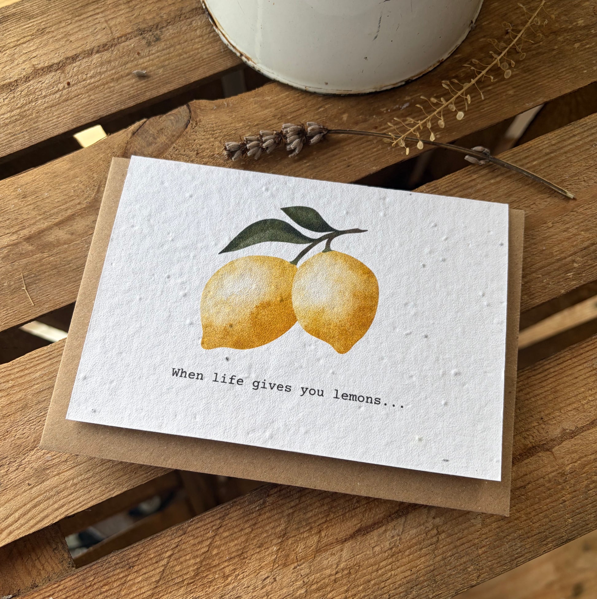 Greeting card with lemons and text on a wooden surface