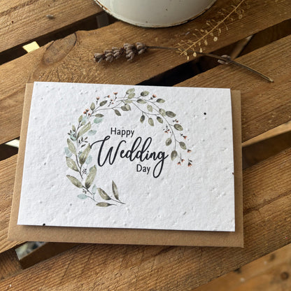 Greeting card with 'Happy Wedding Day' text and floral design on a wooden surface.