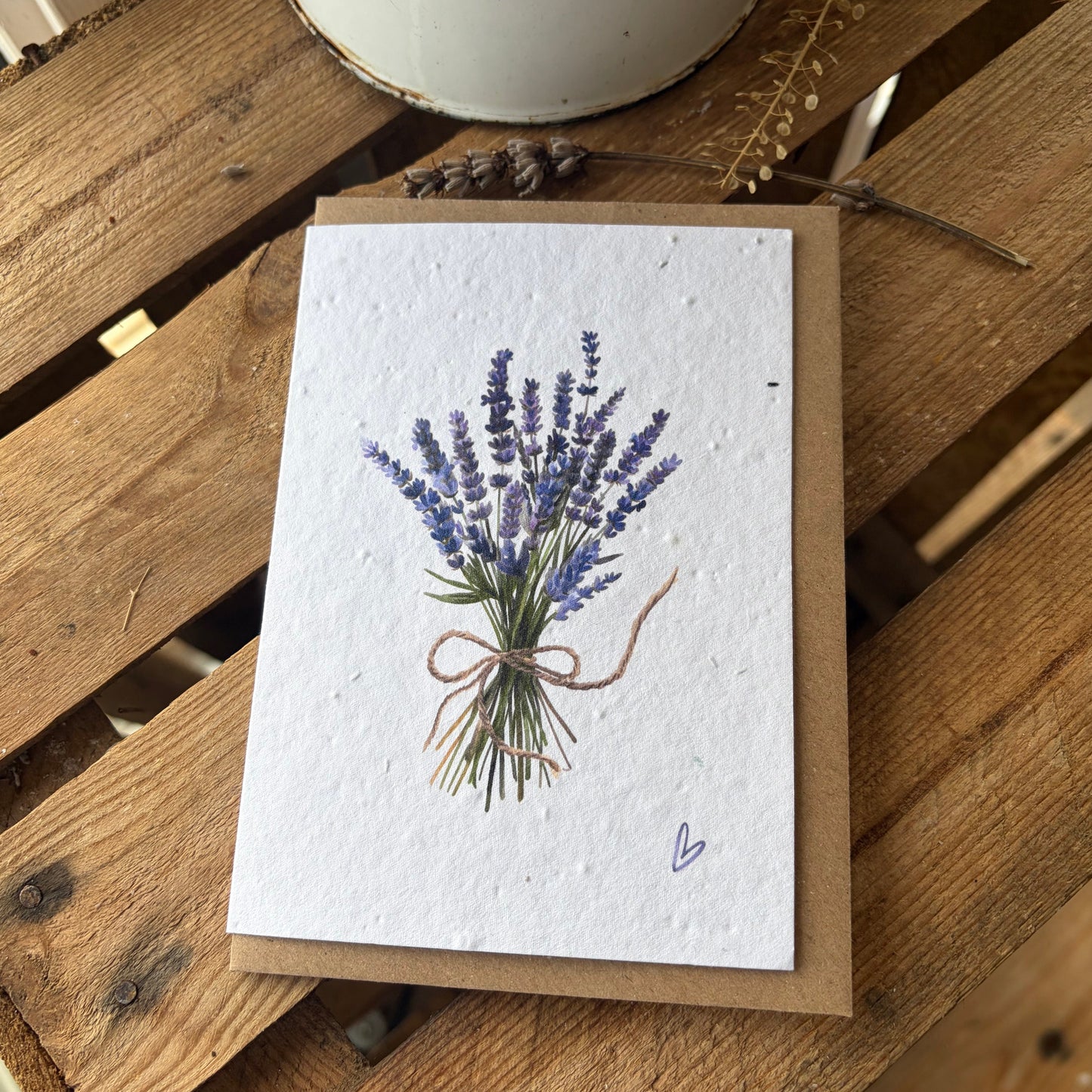 Greeting card with lavender design on a wooden surface
